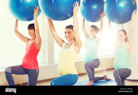 Happy Pregnant Women Exercising With Ball In Gym Stock Photo Alamy