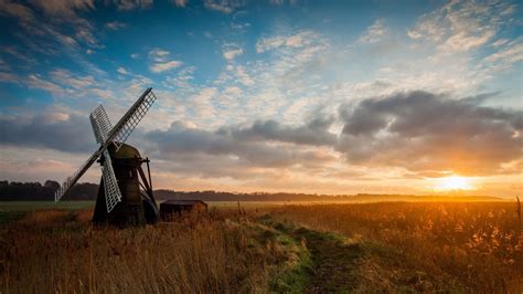 Download 2560x1440 Windmill Sunset Wheat Field Clouds Wallpapers For