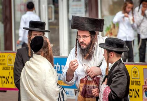A Group Of Hasidim Pilgrims In Traditional Clothing Emotionally Talk