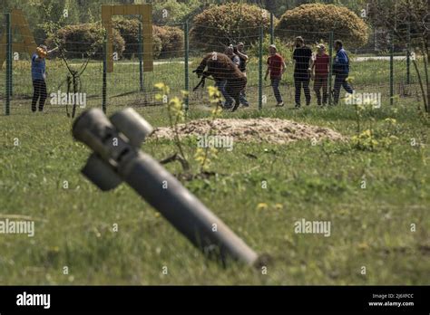 An Unexploded Ordnance Sticks Out Of The Ground As Eco Park Employees Chase After A Llama To Be