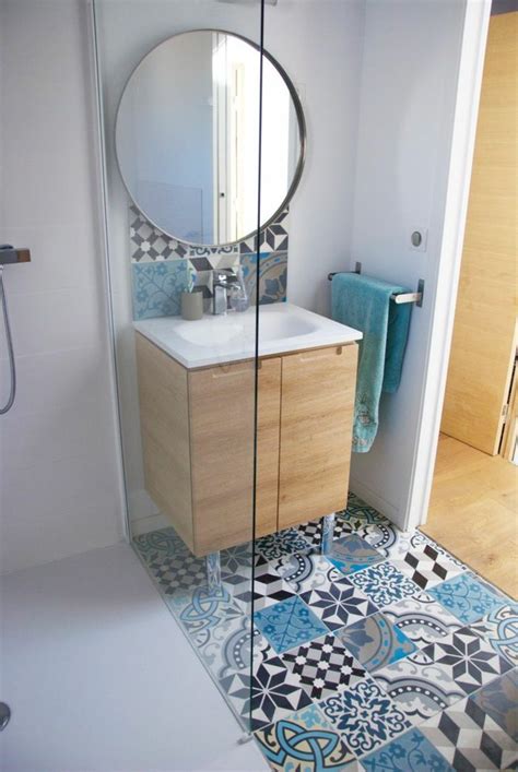A Bathroom With Blue And White Tiles On The Floor Shower Stall And