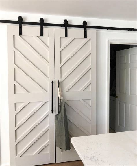 An Open White Door In A Kitchen With Black Hardware And Handles On The