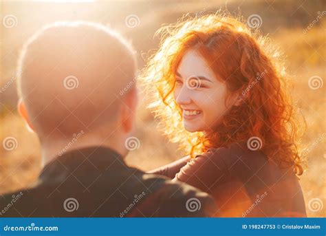 A Young Happy Couple Looking At Each Other And Smiling Stock Image