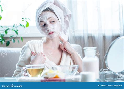 Beautiful Happy Woman With Cosmetic Natural Mask On Her Face Looking At