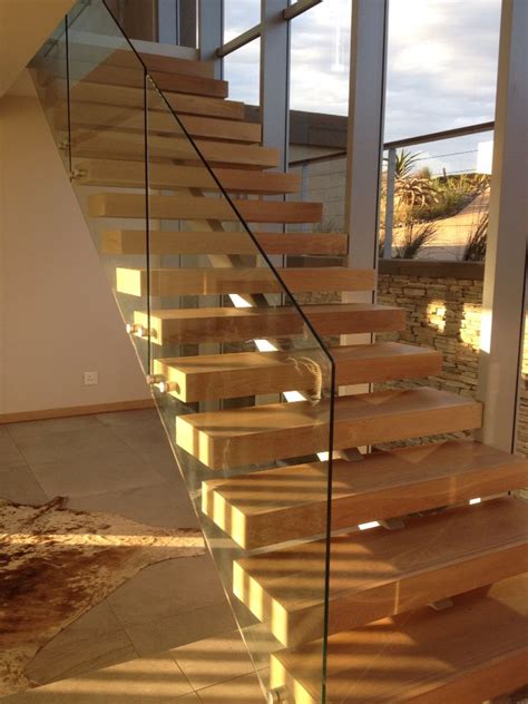Open Stair With Timber Treads And Steel Structure Beneath Glass
