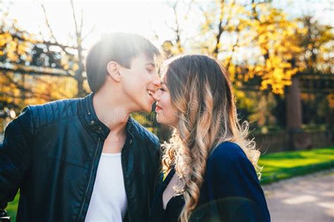 Close Up Portrait Of Boyfriend Kissing Girl On Nose Outdoors Stock