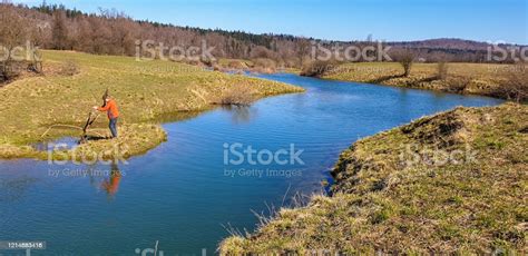 Young Men At Blue River On Karst Field Planinsko Polje Stock Photo