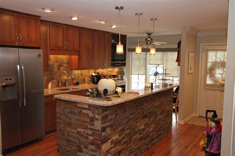 Open Kitchen With Cultured Stone Backsplash And Accent Wall Eclectic