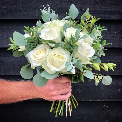 a bridal bouquet of rustic fresh white roses the farmhouse at redcoats jane maples flowers