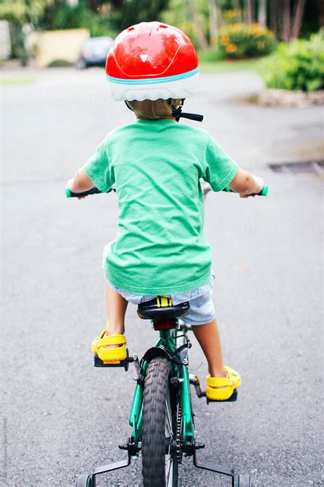 Young Child Riding A Bike With Training Wheels By Stocksy Contributor