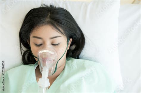 Young Patient Alone In Bed Sleeping In Hospital Bed Oxygen Mask On Her Face Young Beautiful