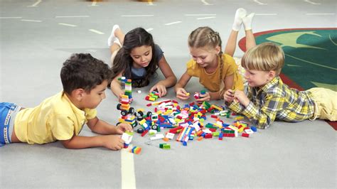 Four Kids Play With Blocks Group Of Children Playing Colorful