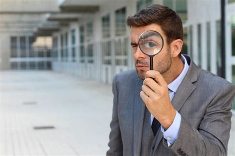 Man Looking Using A Magnifying Glass Stock Photo Download Image Now