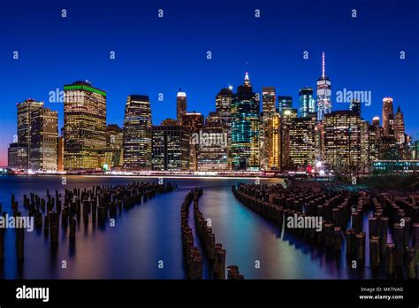 The Nyc Skyline Looking Across From Brooklyn Bridge Park Through The