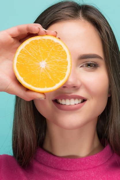 Free Photo Beautiful Womans Face With Juicy Orange