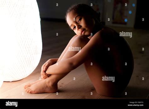Girl Sitting On Floor Nude Hugging Knees Stock Photo Alamy