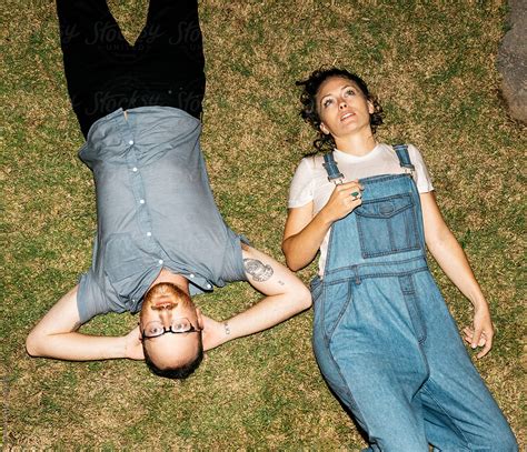 Adventurous Couple Laying In Grass After Getting Wet Fully Clothed In