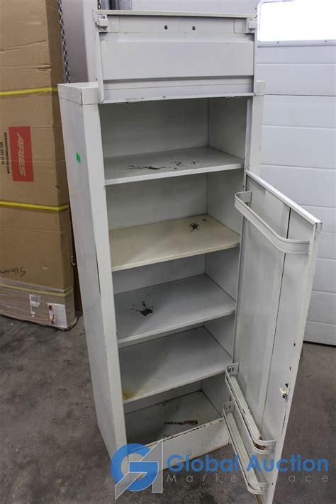 This is basically the medicine cabinet's version of a kangaroo pouch: Vintage Metal Medical Supply Cabinet