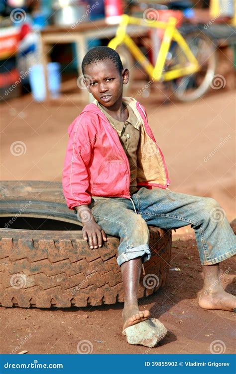 Barefoot Black Boy Resting Sitting On Car Tire Editorial Photography