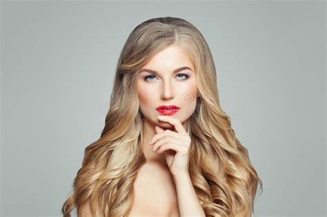 Elegant Blonde Woman With Makeup Long Healthy Curly Hairstyle Gold Jewelry Crown And Earrings