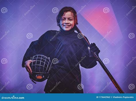 Young Smiling And Relaxed Hockey Player Posing In Uniform For A
