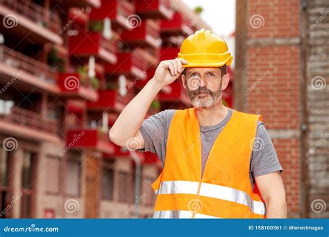 Handsome Construction Worker With Yellow Helmet At Construction Site