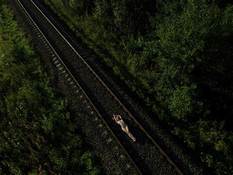 Pretty Naked Woman Lying On Rail Road Photograph By Andrey Guryanov