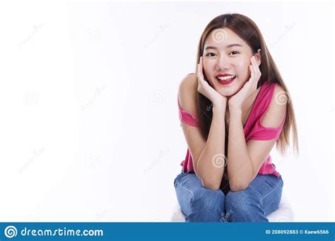 positive girl hipster smiling keep her hand under chin while sitting over isolated white
