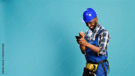 Happy Construction Worker Using Smartphone On Camera Feeling Confident