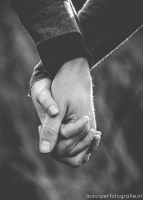 Black And White Photograph Of Two People Holding Hands