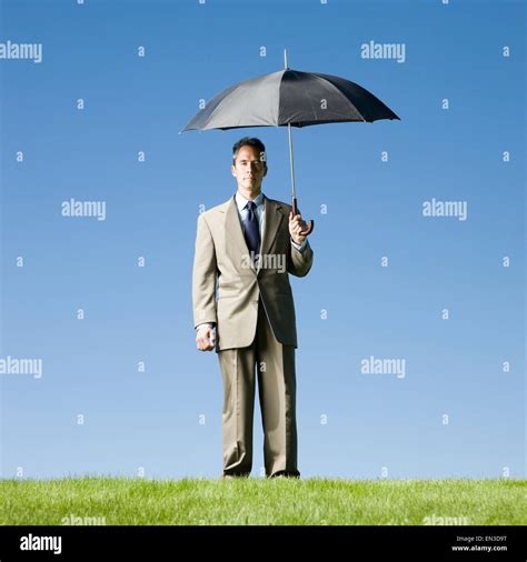Businessman Holding An Umbrella Stock Photo Alamy