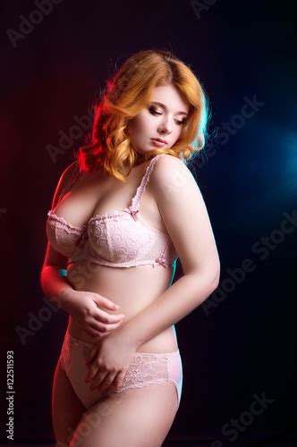 Hot Redhead Blue Eyed Model In Lingerie Posing In The Studio Buy This
