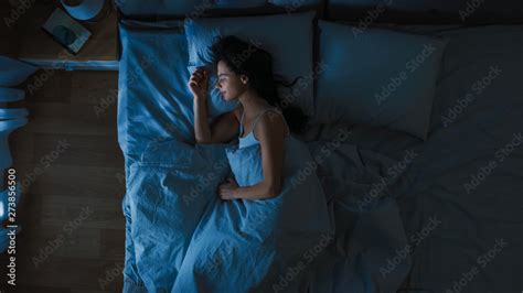 Top View Of Beautiful Young Woman Sleeping Cozily On A Bed In His Bedroom At Night Blue Nightly