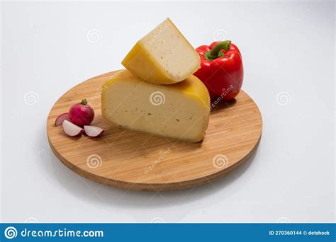Bosnian Traditional Cheese Served On A Wooden Container With Peppers