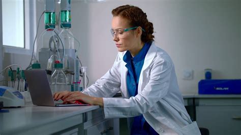 female-scientist-working-in-laboratory-lab-worker-typing-test-report-on ...