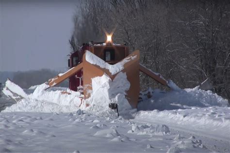 this train with a giant plow on it becomes the ultimate snow clearing machine engaging car