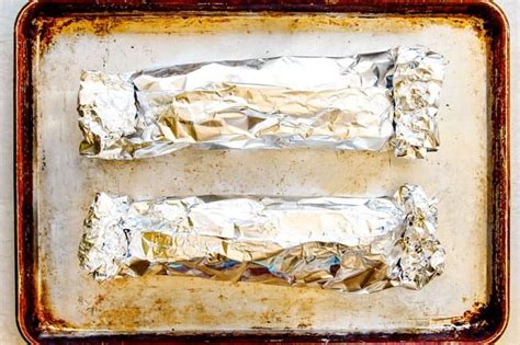 Simply rub the pork with a tasty dry rub, quickly sear, then bake in a hot oven. showing how to bake pork tenderloin in the oven with foil by wrapping up pork tenderloin in foil ...