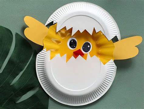 A Paper Plate With A Chicken Cut Out Of Its Side On A Green Surface