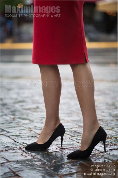 Photo Of Closeup Of Sexy Woman Legs In High Heel Shoes And Red Dress Walking On Cobbled City