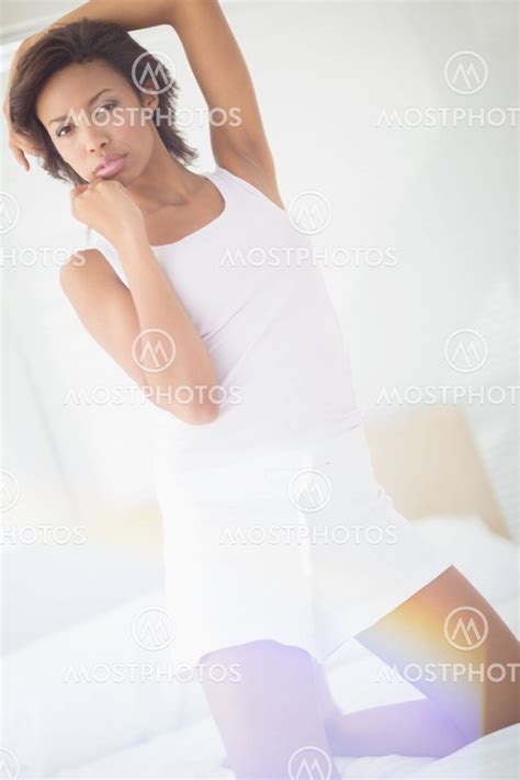 Pouting Sexy Brunette Kneel By Wavebreakmedia Mostphotos