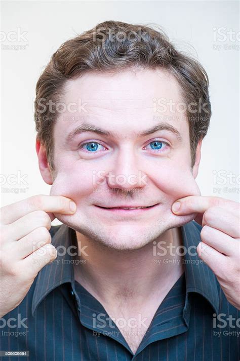Portrait Of Man Points On His Cheeks Human Face Parts Stock Photo