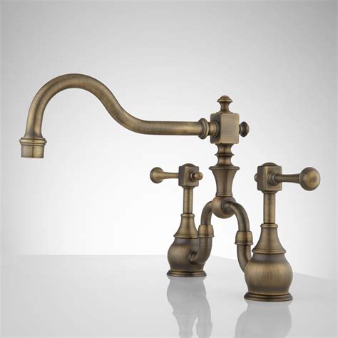 The henry gooseneck two hole kitchen mixer with metal lever handles is available in unlaquered brass and antique brass for $2,071 from waterworks. Moen Antique Brass Faucets