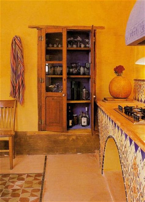A Kitchen With Yellow Walls And Tile Flooring