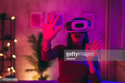Young Woman Playing A Scary Game On A Virtual Reality Headset At Home