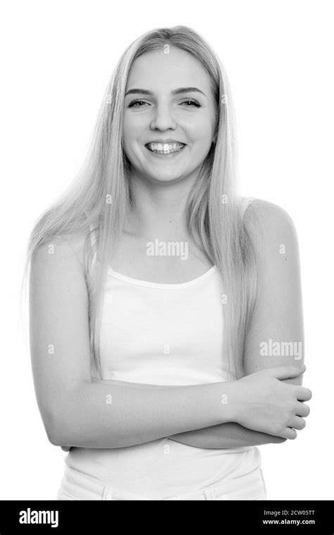 Studio Shot Of Young Happy Teenage Girl Smiling With Arms Crossed Stock