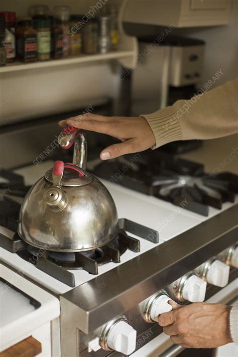 To save space, choose a whistling. Stainless steel kettle on a stove - Stock Image - F012 ...