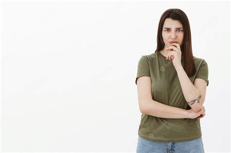 free photo woman worried and hesitant as hearing something disturbing thinking frowning from