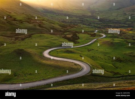 Long Winding Country Road Leading Through British Countryside Seen From