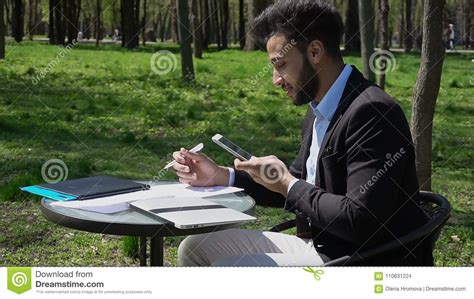 Freelancer Doing Paper Work And Talking On Phone R Stock Photo Image
