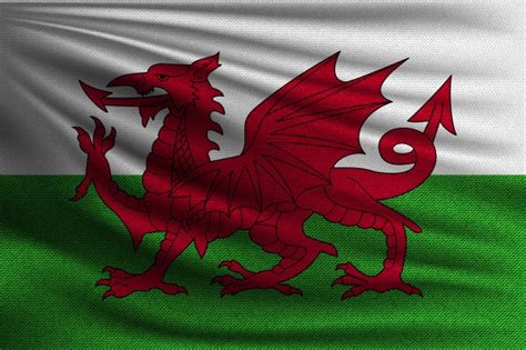 Les coutures du drapeau owain glyndwr pays de galles royal sont renforcées et les bords sont doubles. Mains Agitant Des Drapeaux Du Pays De Galles | Photo Gratuite
